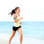 21255909-running-woman-jogging-on-beach-listening-to-music-in-earphones-from-smart-phone-mp3-player-smartphon